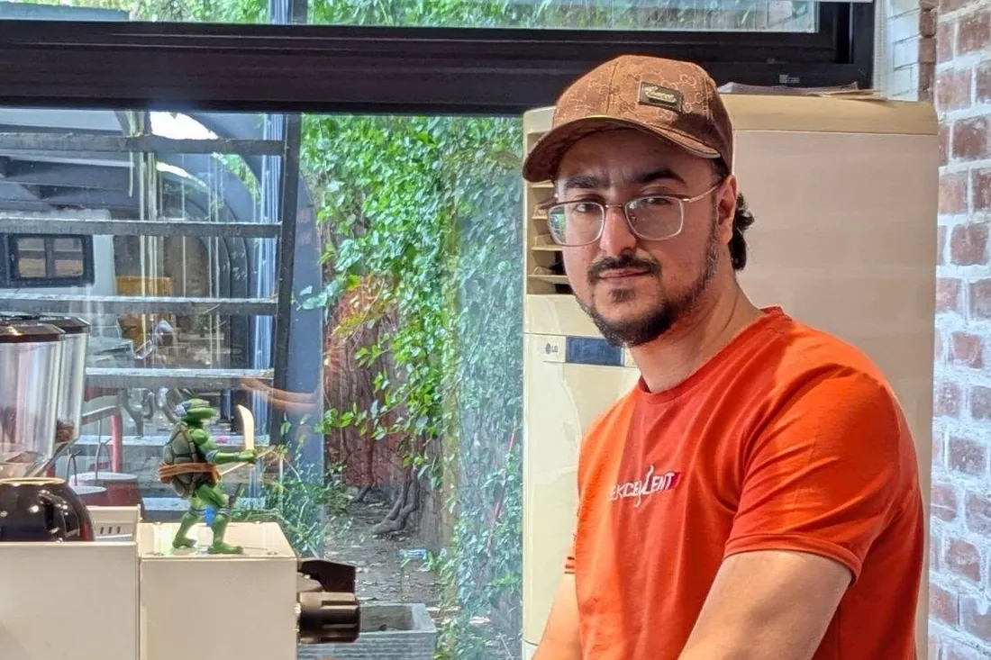 Ahmed Hussain locking a portafilter into an espresso machine during equipment setup