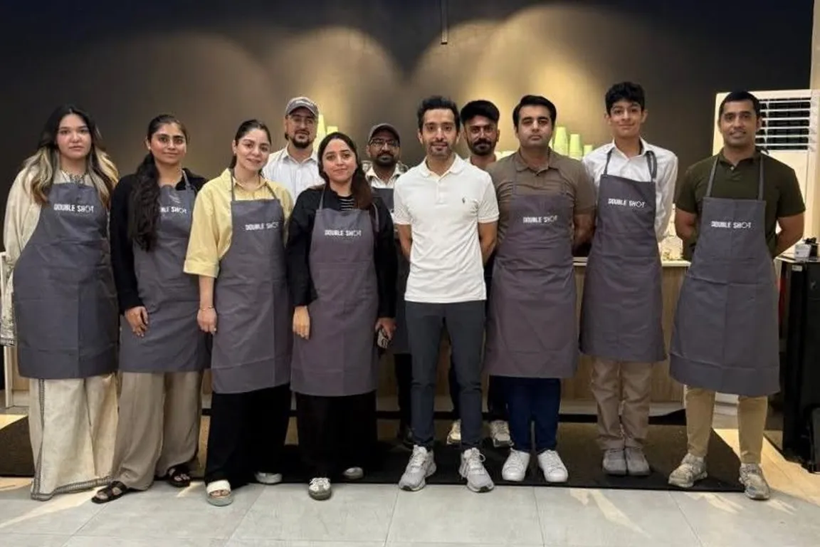 A café team of baristas in aprons after their training