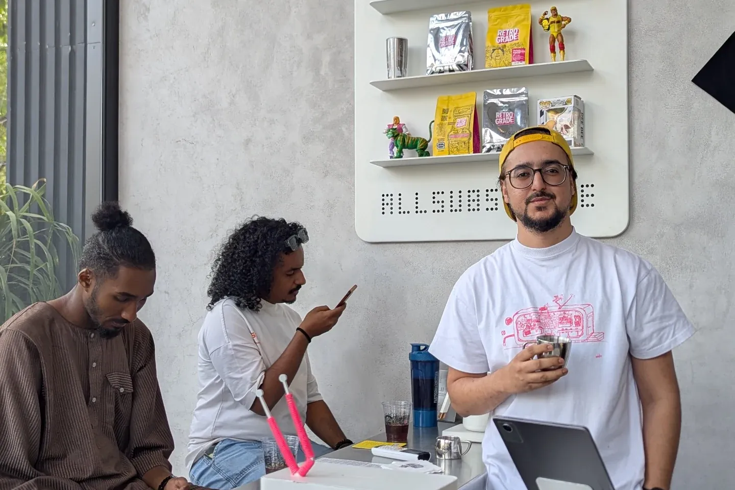 Ahmed Hussain at the counter of a busy new coffee shop in Lahore