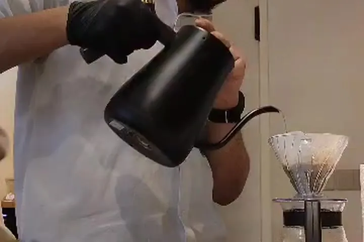 A pour-over being brewed with a gooseneck kettle to taste specialty beans