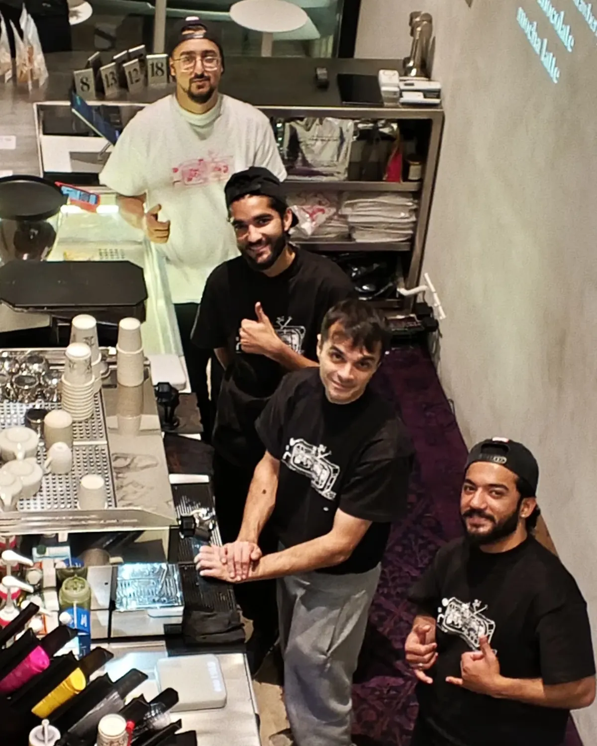 Baristas trained by Ahmed Hussain behind their coffee bar